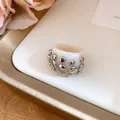Detailed view of a fashionable white resin ring decorated with silver metallic studs - Ring (Silver-Beige-Iron) / Beige