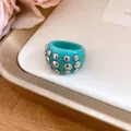 Close-up detail of a turquoise resin dome ring featuring silver round rivet studs decorations - Ring (Silver-Cyan-Iron) / Cyan