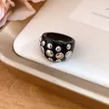 Chic black resin wide ring featuring polished silver metal rivets for a designer look. - Ring (Silver-Black-Iron) / Black