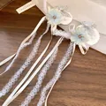 Close-up of elegant fabric flower hair clips with lace tassels and rhinestone butterflies - Duckbill Clip (HH9859) / Single Piece / Blue & White