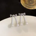 Silberne Zirkon-Schleifenohrringe mit eleganten langen weißen Perlenquasten für Damen - Schleife Quaste Stecker / Silber