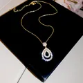 Detail of teardrop pendant necklace with sparkling cubic zirconia in gold finish - Gold