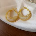 Macro detail of golden mesh hoop earrings showcasing the intricate glass weave design - 925 Silver Post Style / Gold