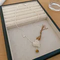 Detailed view of minimalist silver bead necklace with heart pendant on jewelry tray. - Heart Style with Round Stone Pendant / Silver