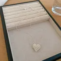 Detail view of a minimalist silver beaded heart pendant necklace on a jewelry tray. - Adjustable Minimalist Beaded Heart Pendant / Silver
