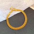 Detailed view of a gold-plated mesh chain bracelet with a secure lobster clasp. - Gold
