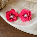 Close-up of matte pink flower stud earrings with pearl center on silk background - Flower Style (HE31698) / Pink