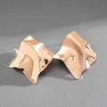 Detailed view of gold irregular geometric stud earrings with high-shine metallic finish - Gold