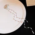 Detail of a silver shell hair clip featuring long elegant double pearl chain tassels - Double Chain Artificial Pearl Tassel Style / Silver