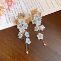 French vintage earrings featuring white flower petals, gold leaves and elegant long tassels - Silver Post-Gold-White-Blue