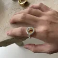 Detailed view of a Maillard-style silver open ring with a circular amber resin centerpiece - Round Resin Open Ring / Silver-Light Brown