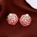 Detailed view of elegant retro palace style earrings with pink gemstones and large pearls - Gold Base / Pink