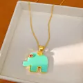 Close-up of a bohemian resin elephant pendant necklace with gold chain in a jewelry box - Elephant Pendant Necklace (HN12577) / Mint Green