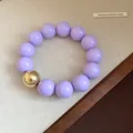 Fashionable chunky purple and gold bead bracelet with a smooth glossy bead finish - Bracelet / Light Purple