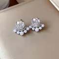 Detailed view of elegant zircon earrings with small pearls and sparkling micro-insets - Silver Needle Silver Style / White