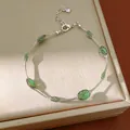 Elegante zilverkleurige kettingarmband met levendige groene ovale mesh-kraal accenten - Zilver-Groen