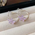 Detailed macro view of elegant purple resin flower hoop earrings on a beige velvet tray - Silver Needle / Silver-Pink