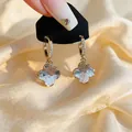Elegant gold-plated hoop earrings with textured light blue clover dangles and crystals - Gold Clover Ear Cuffs
