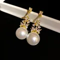 Elegant vintage style pearl and zircon drop earrings in a sparkling gold finish. - Tops / Gold