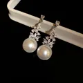 Elegant vintage-style drop earrings featuring large white pearls and floral zircon accents. - Silver