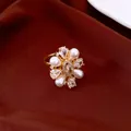 Detailed view of a vintage floral ring with pearls and brilliant zircons - Gold