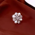 Close-up detail of elegant 14k gold plated flower ring with white pearls and shiny CZ - Silver