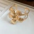 Macro detail view of vintage gold flower cuff bracelet with intricate metal petal texture - Floral Style (9#)