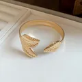 Macro detail of a vintage gold metal cuff bracelet with detailed leaf vein patterns - Double Leaf Texture Style (1#)