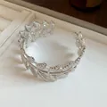 Macro view showing the intricate leaf engraving on the silver-finished metal cuff bracelet - Wrapped Leaf Style (6#)