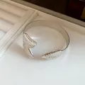 Close-up of vintage silver leaf-patterned open metal bangle for women's jewelry - Leaf Grain Style (2#)