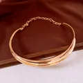 Close-up of elegant irregular metallic gold choker with unique folded design - Simple Smooth Wrapped Style / Gold