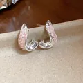 Detailed view of silver-tone irregular twisted earrings with sparkly pink glass accents - Irregular Twisted Style / Pink