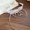 Detailed macro view of a white lace choker necklace with elegant pearls and fabric flowers - Eco White