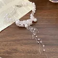 Elegant white pearl beaded necklace with frosted flower charms and silver tassels. - Silver White