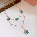 Detailed view of layered Y-shape necklace with turquoise enamel flowers and faux pearls - Necklace (HN12502) / Gold-Blue