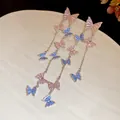 Detailed close-up view of silver butterfly tassel earrings with pink and blue stones - Butterfly Tassel Style / Silver Needle / Pink and Blue