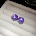 Close-up of purple resin ball stud earrings resting on white velvet jewelry tray - Silver Earring Post Style / Purple