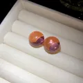 Close-up of translucent dual-tone resin round stud earrings in white velvet box - Silver Earring Post Style / Pink