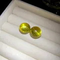 Detailed macro view of translucent lime yellow resin round stud earrings in white tray - Silver Earring Post Style / Yellow