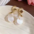 Detailed macro shot of vintage French style gold earrings with white shell petal charms - Tassel Stud Earrings (HE33805) / Gold-White