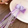 Detailed macro view of a purple rose hair clip with white lace ribbons and bead accents - Duckbill Hair Clips / Purple