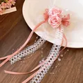 Close-up detail of pink floral hair clip with delicate lace and satin ribbons - Duckbill Hair Clips / Pink