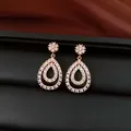 Detailed view of 18K gold plated teardrop dangle earrings with sparkling white cubic zirconia. - Teardrop Pendant / Gold