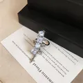 Close-up detail of elegant silver ear cuff with sparkling zircons and a star charm - Single Piece / Silver