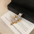 Detail shot of elegant gold-plated star ear cuff with multi-shape cubic zirconia - Single Piece / Gold