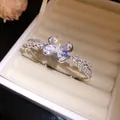 Close-up of elegant double-layered silver bangle with sparkling zircon butterfly detail - Silver-Pink