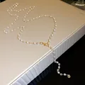 Detailed close-up shot showing elegant pearls and crystal beads on a gold necklace chain - Single Layer / Gold White