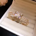 Close-up of gold butterfly bracelet featuring sparkling zircon stones in a jewelry box. - Gold-Clear