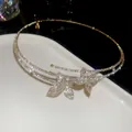 Close-up of luxury double-layer rhinestone necklace with sparkling butterfly motifs - Choker Necklace / Gold