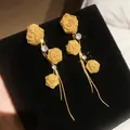 Detailed view of elegant gold mesh rose earrings with sparkling stones and long tassels. - Silver Post Long Tassel Rose / Gold